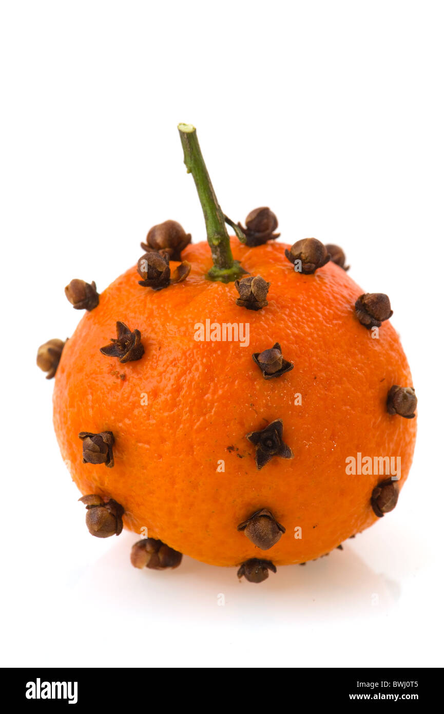 Orange fruit studded with cloves isolated white background Stock Photo
