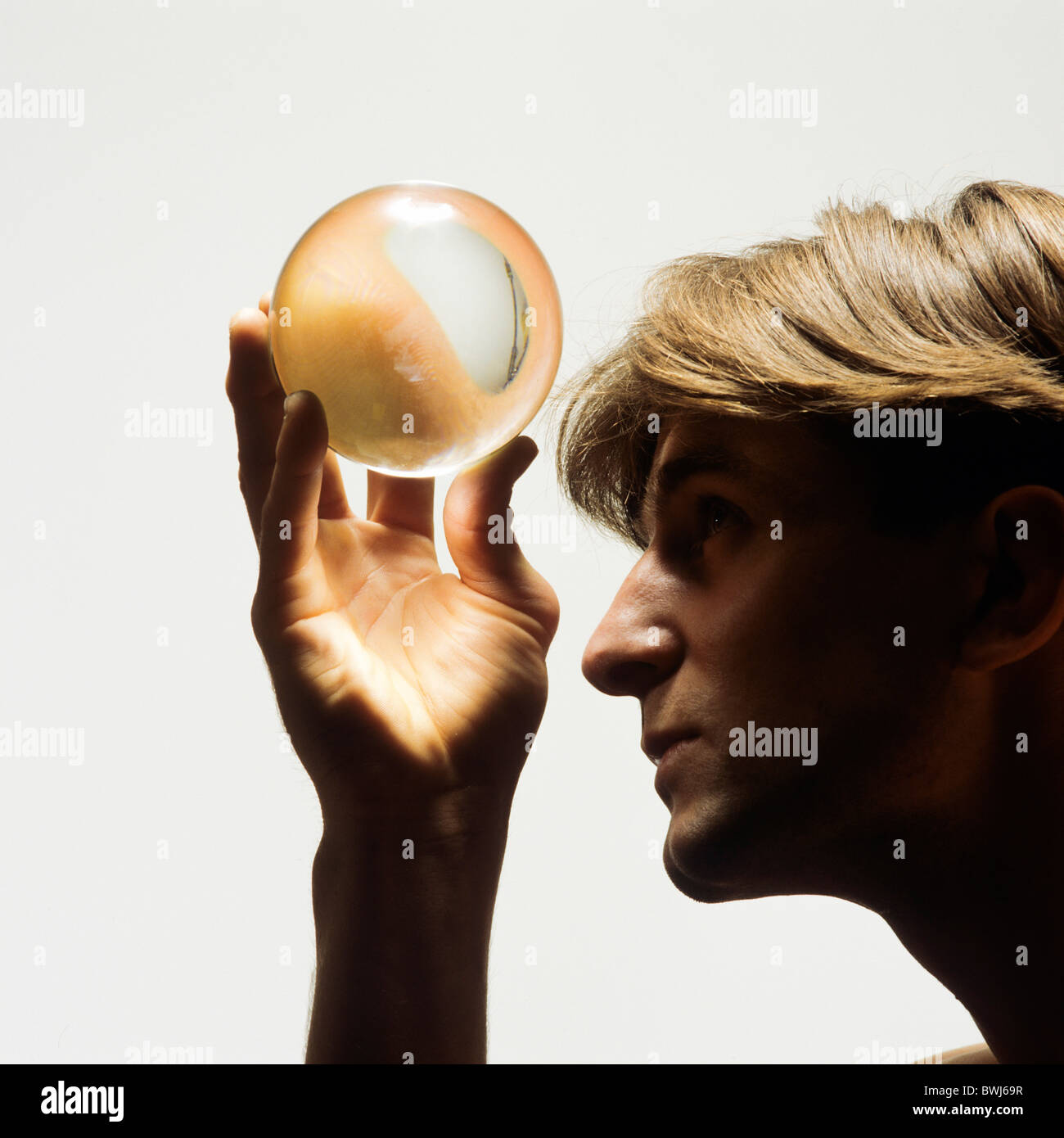 MR MAN LOOKING UP INTO A CRYSTAL BALL Stock Photo - Alamy