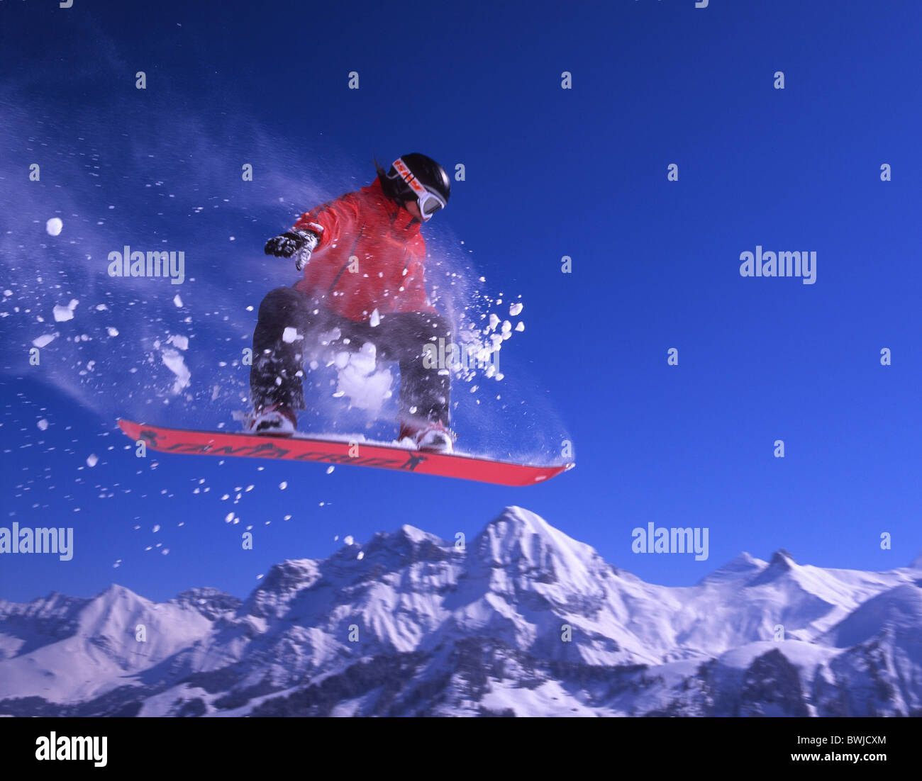 winter snowboard Snowboard Snowboarder jump action Alps deep snow mountains winter sports Switzerland Europ Stock Photo