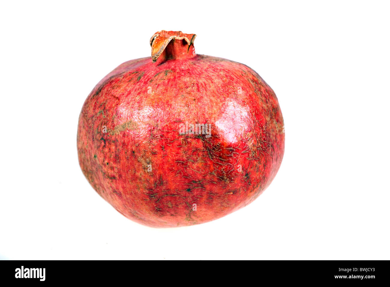 Ripe Pomegranate isolated over white background Stock Photo