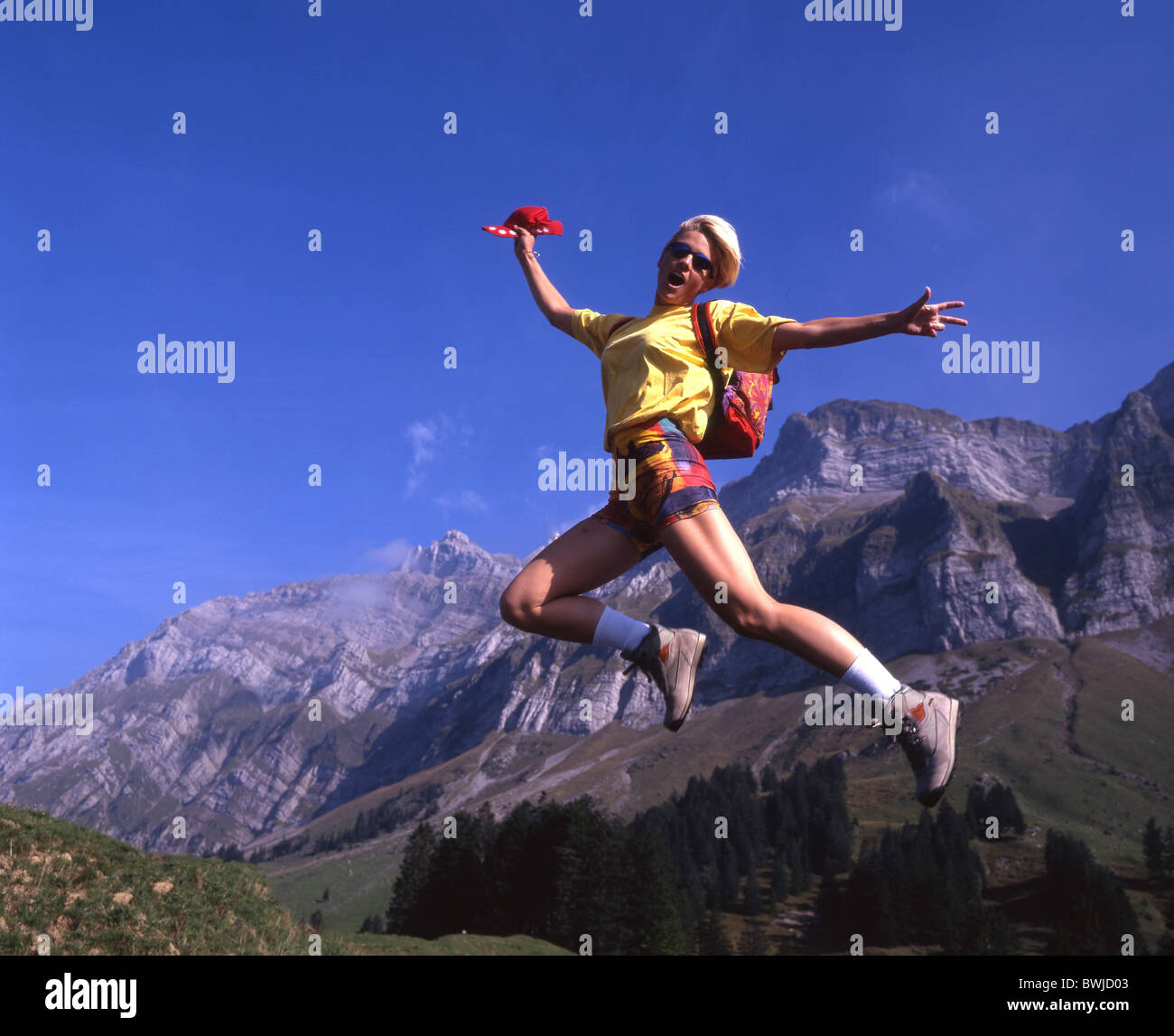 hiking mountain hiking woman teenager youngsters jump action fun joke mountains Alps Alpstein spare time Stock Photo