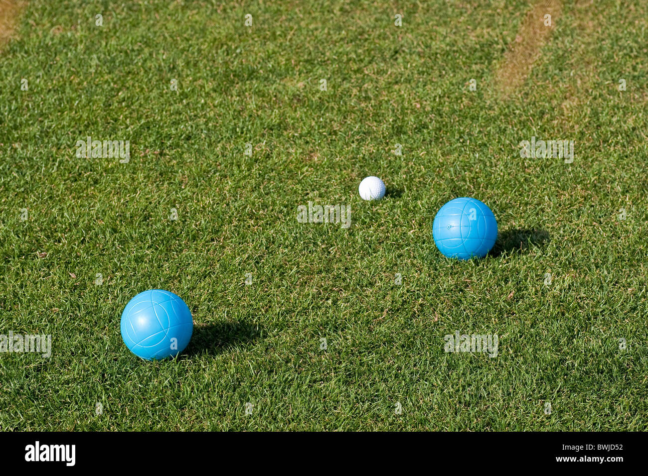 Blue and White Bocce Balls on a green grass lawn Stock Photo
