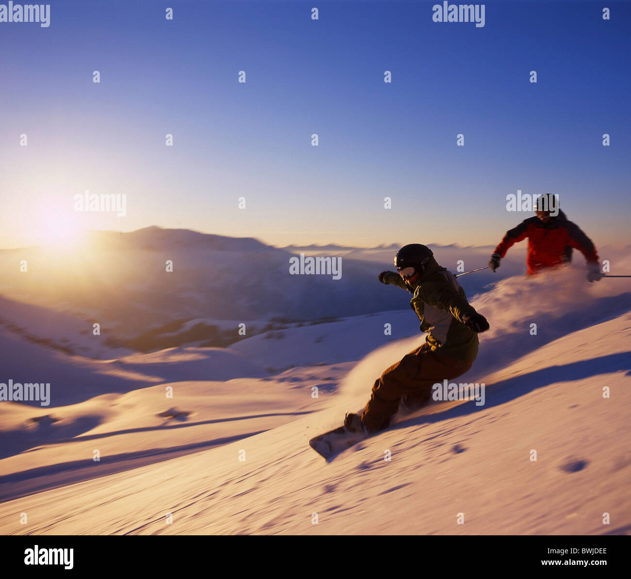 two persons Snowboarder snowboard Snowboarding winter winter sports deep snow snow sports mountains Alps m Stock Photo