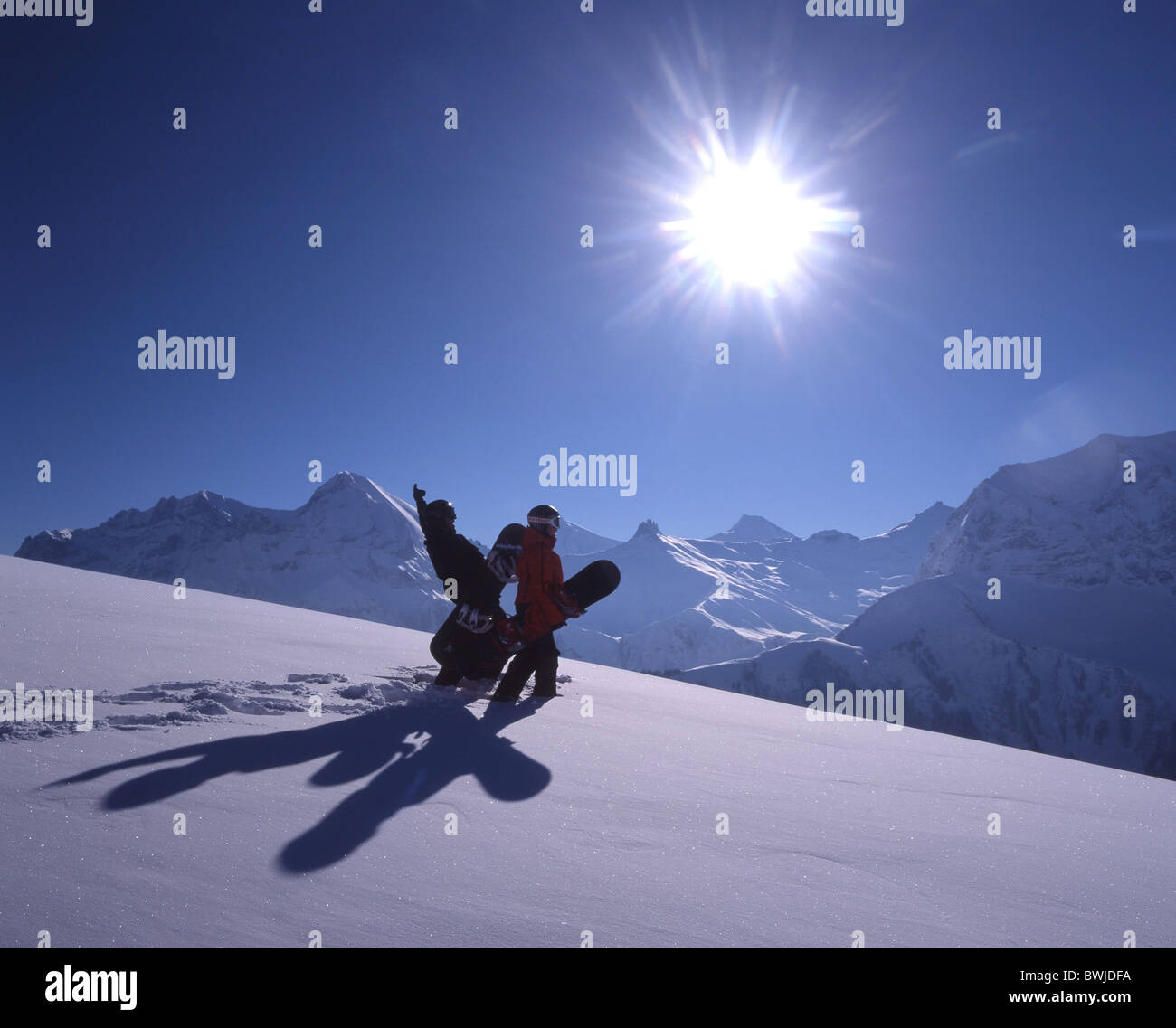 two persons Snowboarder sun cheering joy nice weather blue sky snowboard Snowboarding winter winter sports Stock Photo