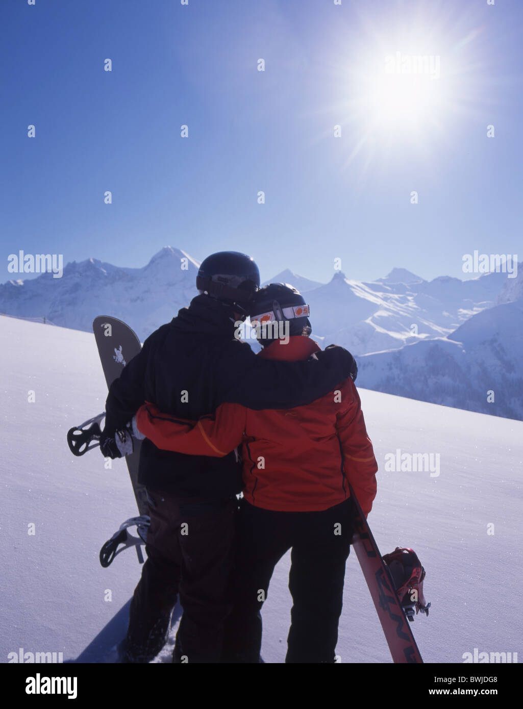 Two Snowboarder couple sun romantical sunbath snowboard Snowboarding snow mountains Alps Bernese Oberland A Stock Photo