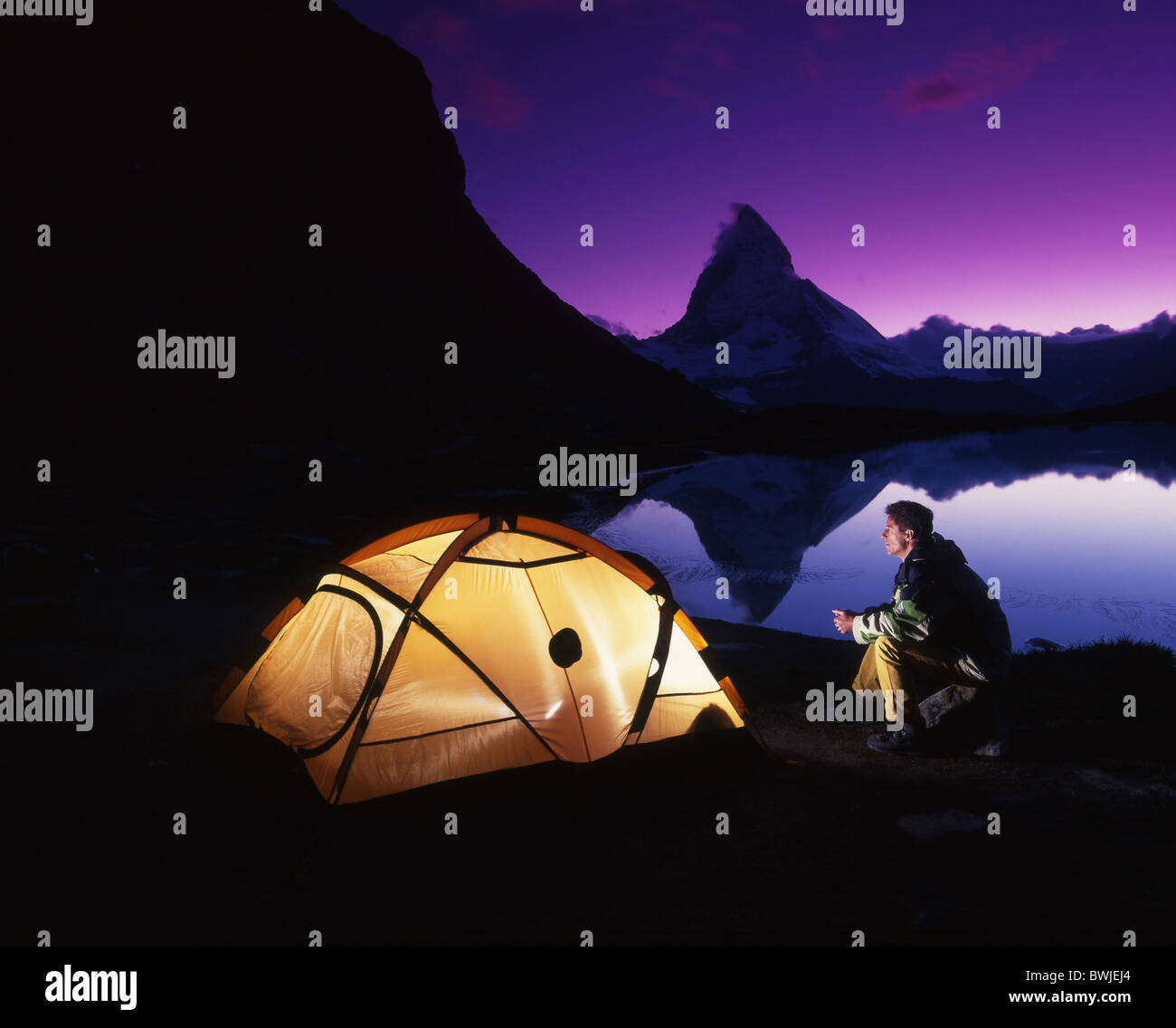 man Matterhorn camping tent tent camp illuminated light lake mountain lake Riffelsee dusk twilight at nig Stock Photo