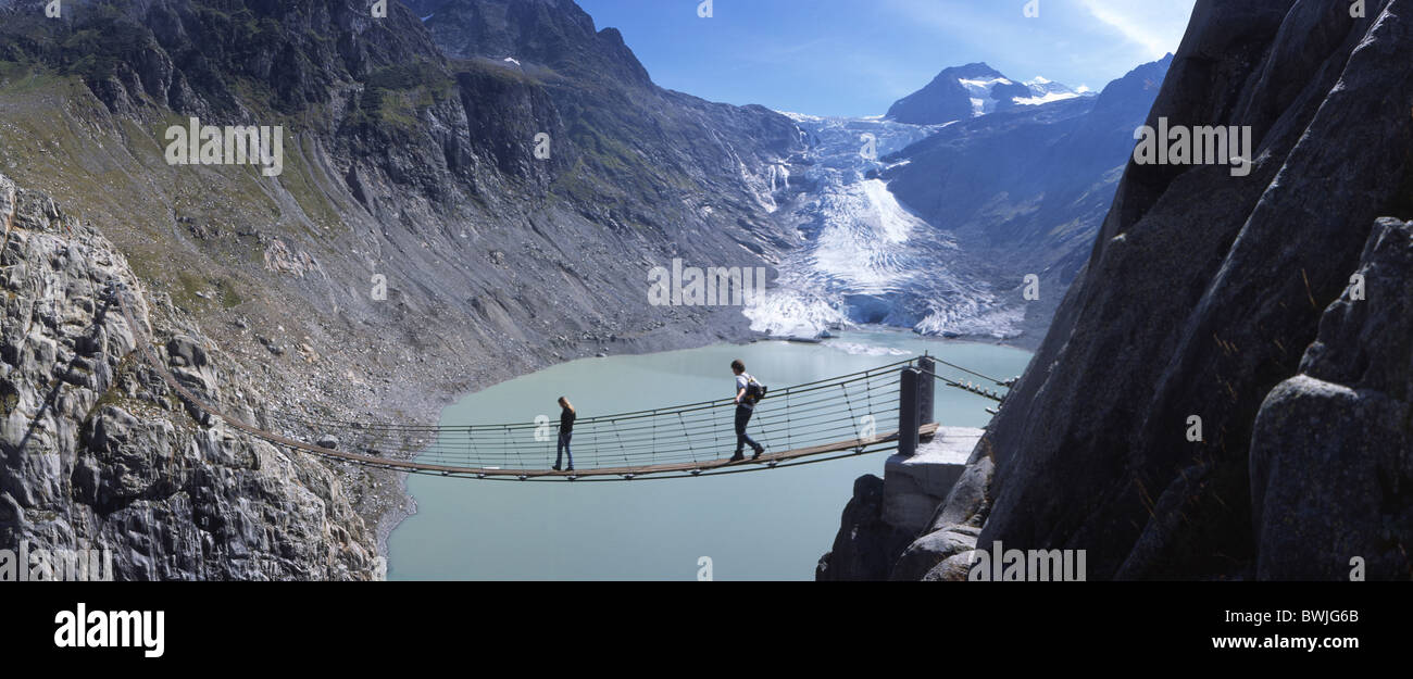 suspension bridge bridge footbridge Triftgletscher glacier lake mountains Alps Canton Bern Bernese Oberland Stock Photo