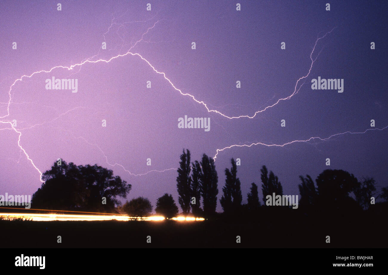 thunderstorms flash flashes at night night weather street traffic Stock