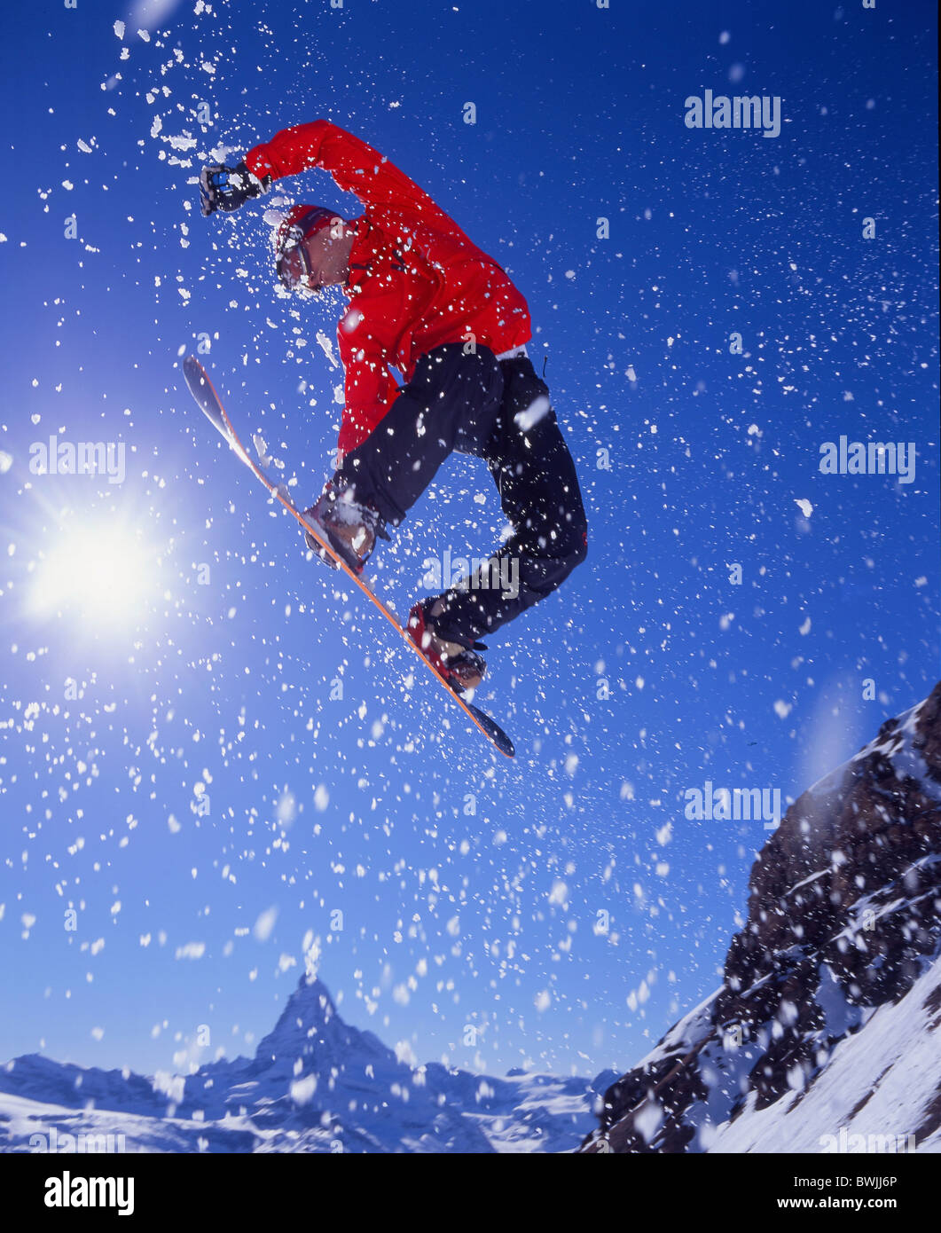 Matterhorn snowboard Snowboarder jump action Snowboarding Snowboard mountains Alps canton Valais winter spor Stock Photo