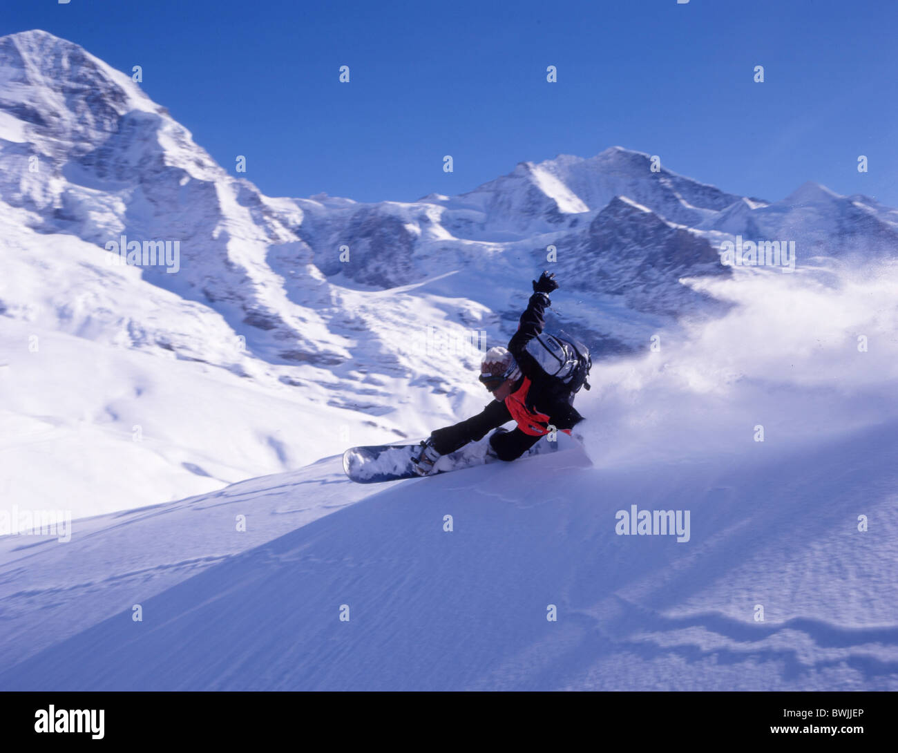 Snowboarder snowboard Snowboarding deep snow Free riding winter sports mountains Alps snow winter sports Kl Stock Photo