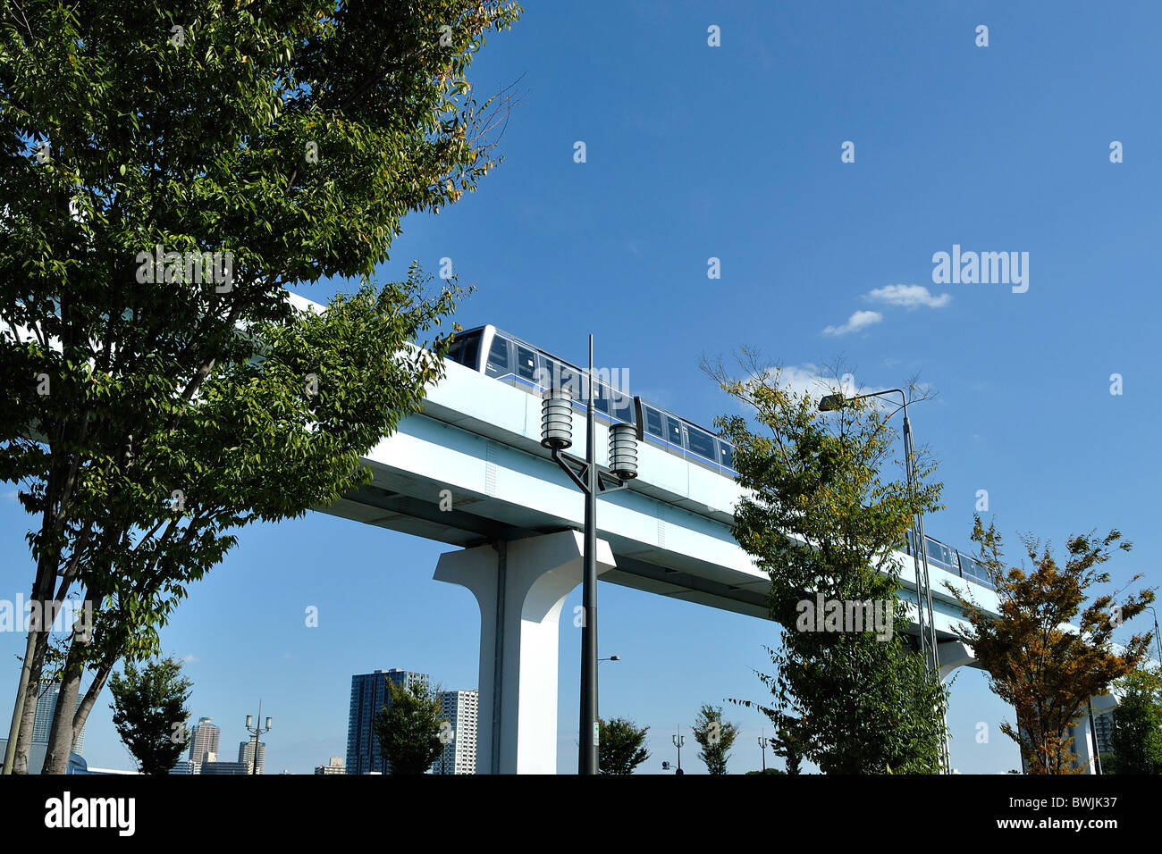 Train passing by on elevated track of Yurikamome railway system in Tokyo (Japan) Stock Photo