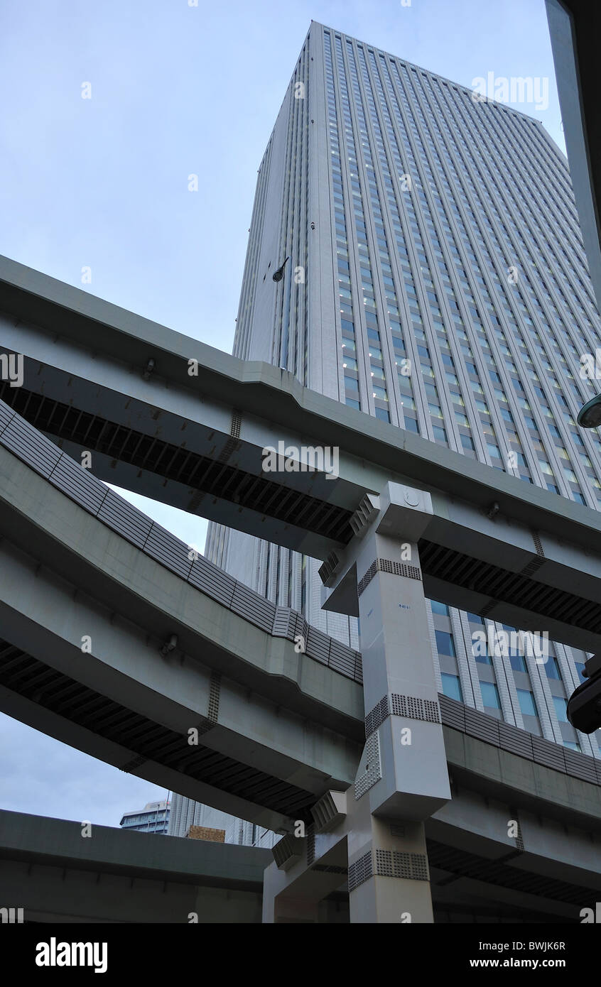 Low angle shot of "Sunshine City "skyscraper behind 2 storey freeway junction in Tokyo`s Ikebukuro district (Japan) Stock Photo