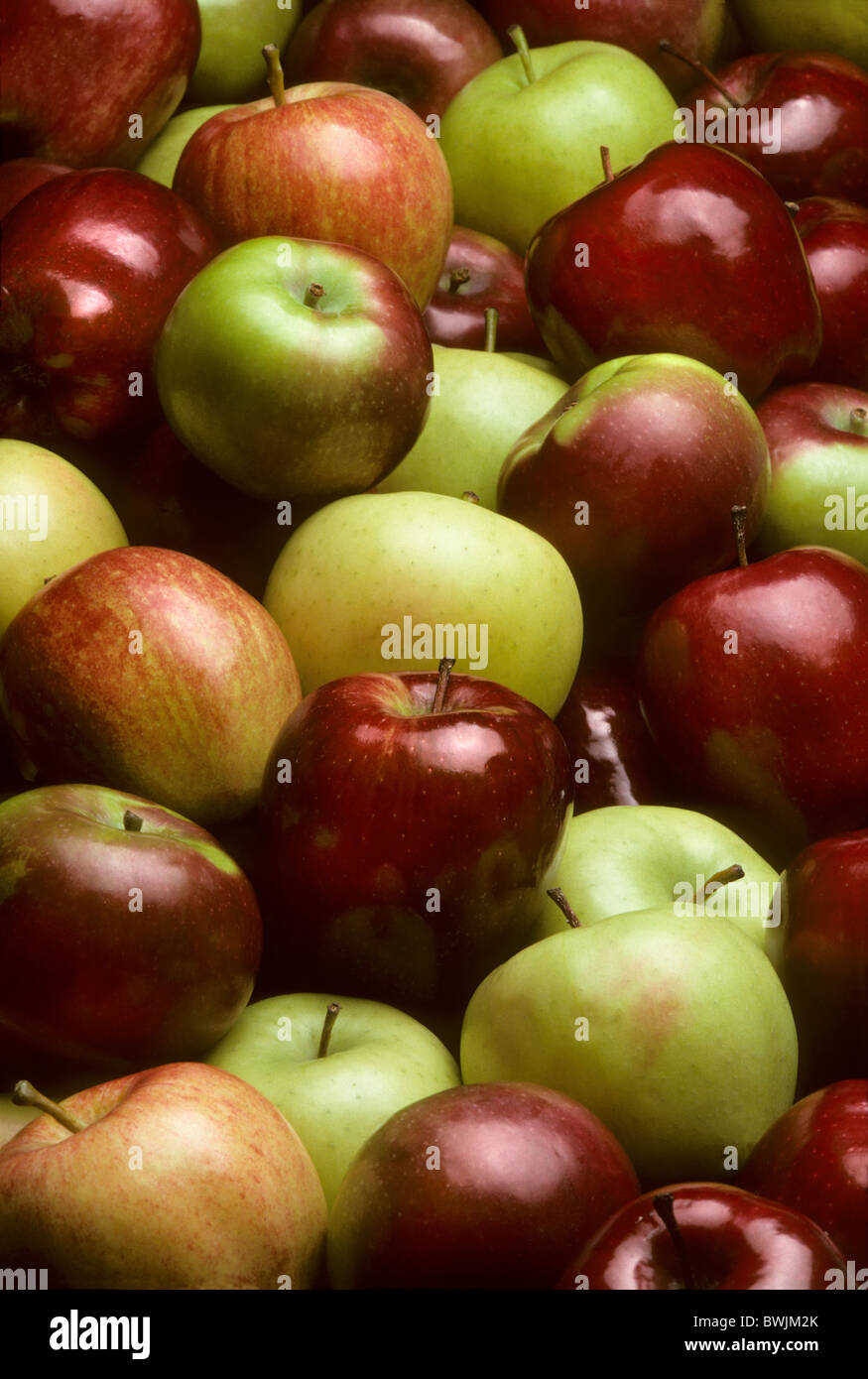 Pile of mixed varieties of apples including Red Delicious, Golden