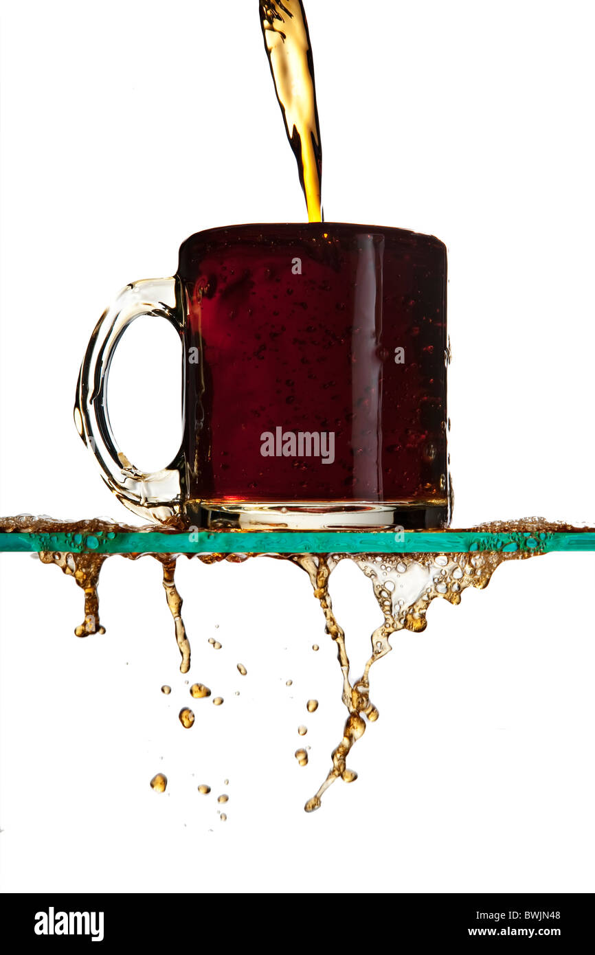 Pouring a cup of coffee, coffee overflowing and spilling onto the table Stock Photo Alamy