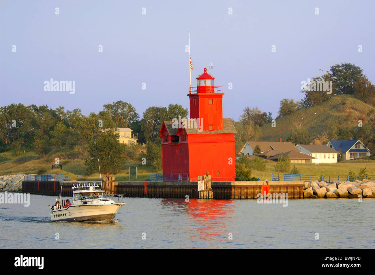 Big Red Lighthouse lighthouse red Boat motorboat Michigan lake shore lake Lake Michigan Michigan USA Americ Stock Photo