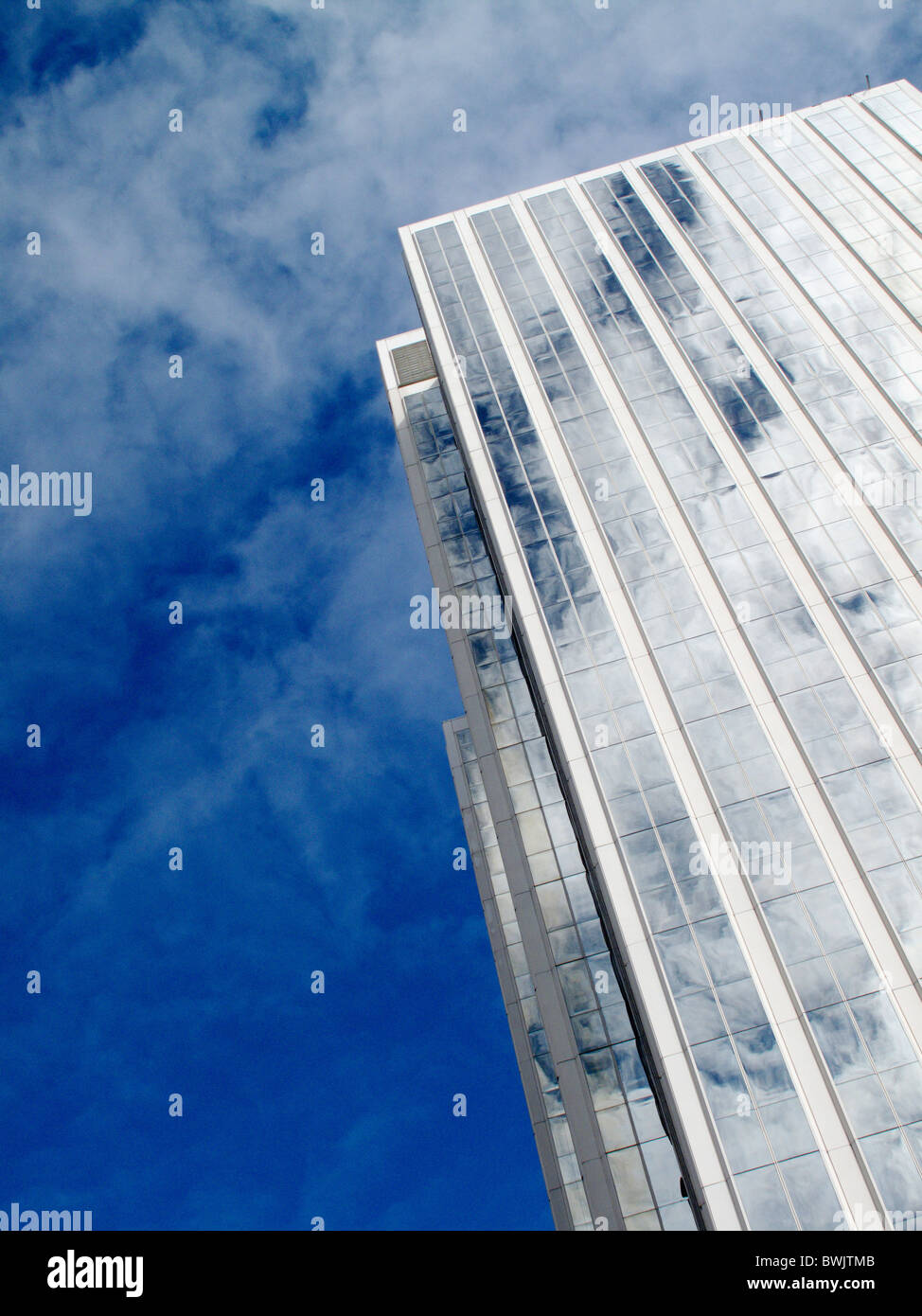 Clouds and sky reflected in the mirror surface of a skyscraper  Stock Photo