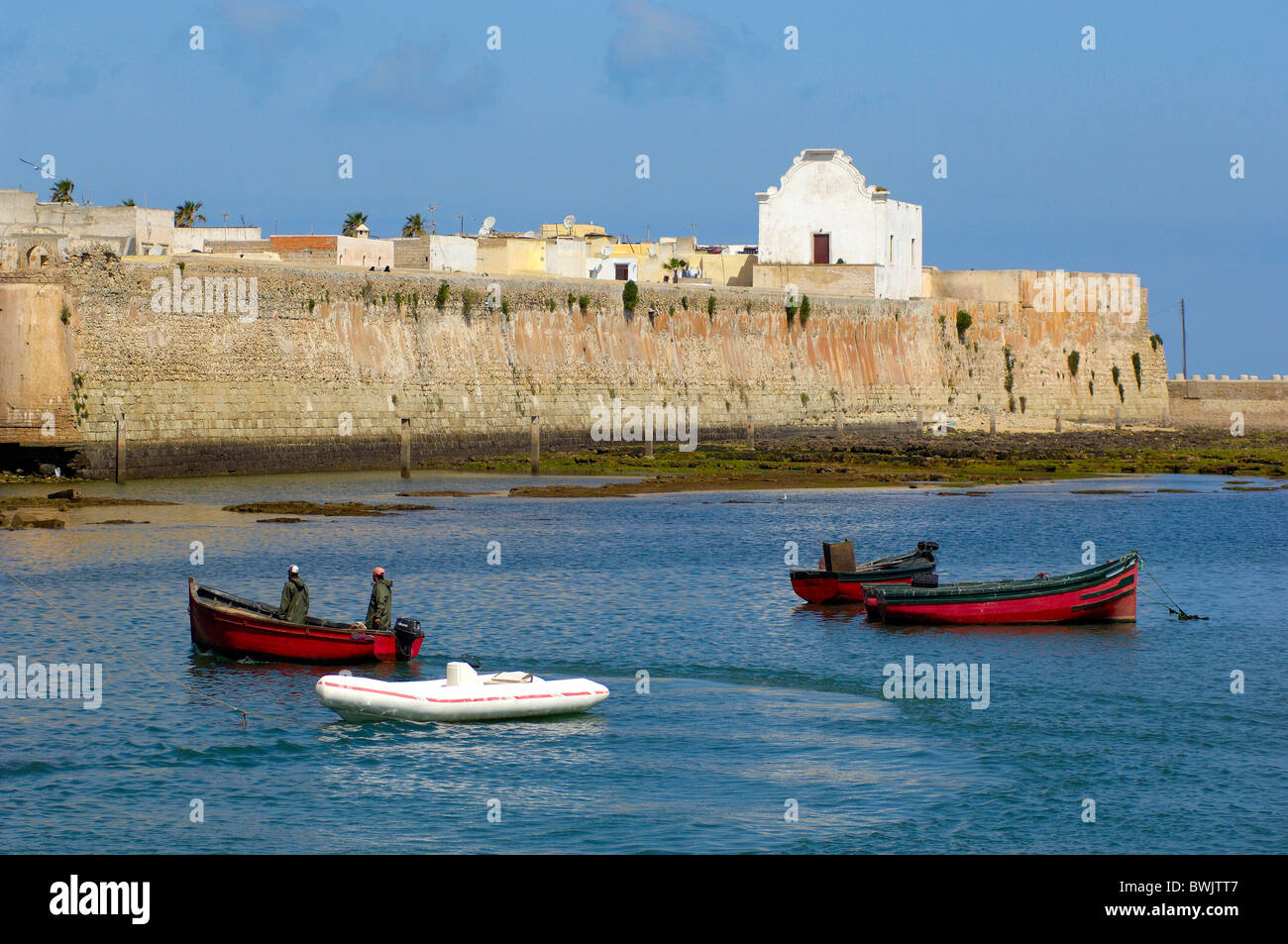 Fischer boats fishing boats town wall Old Town harbour port coast sea El Jadida Morocco Africa North Afric Stock Photo
