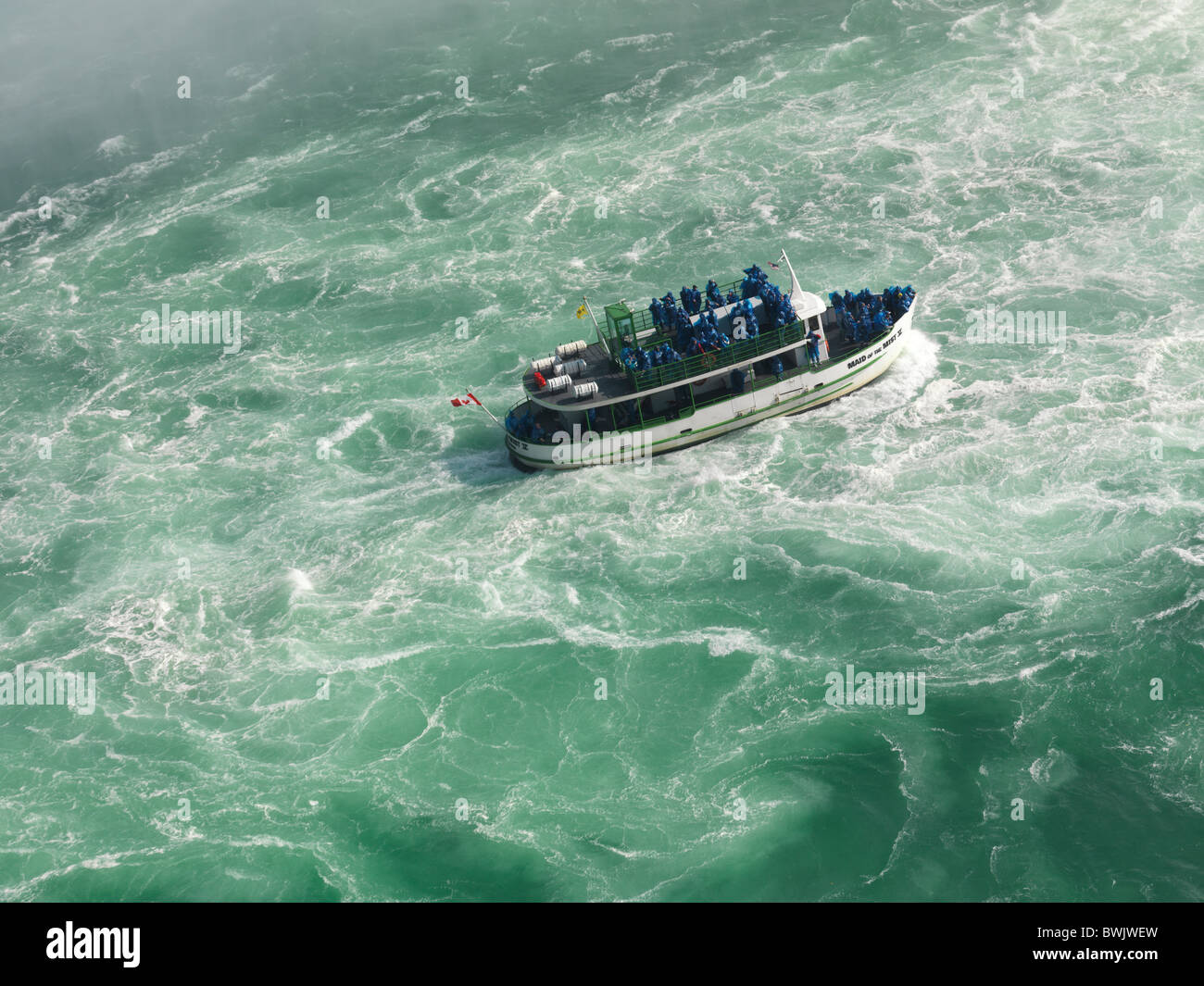 People on Made of the Mist boat ride approaching Niagara Falls Horseshoe Stock Photo