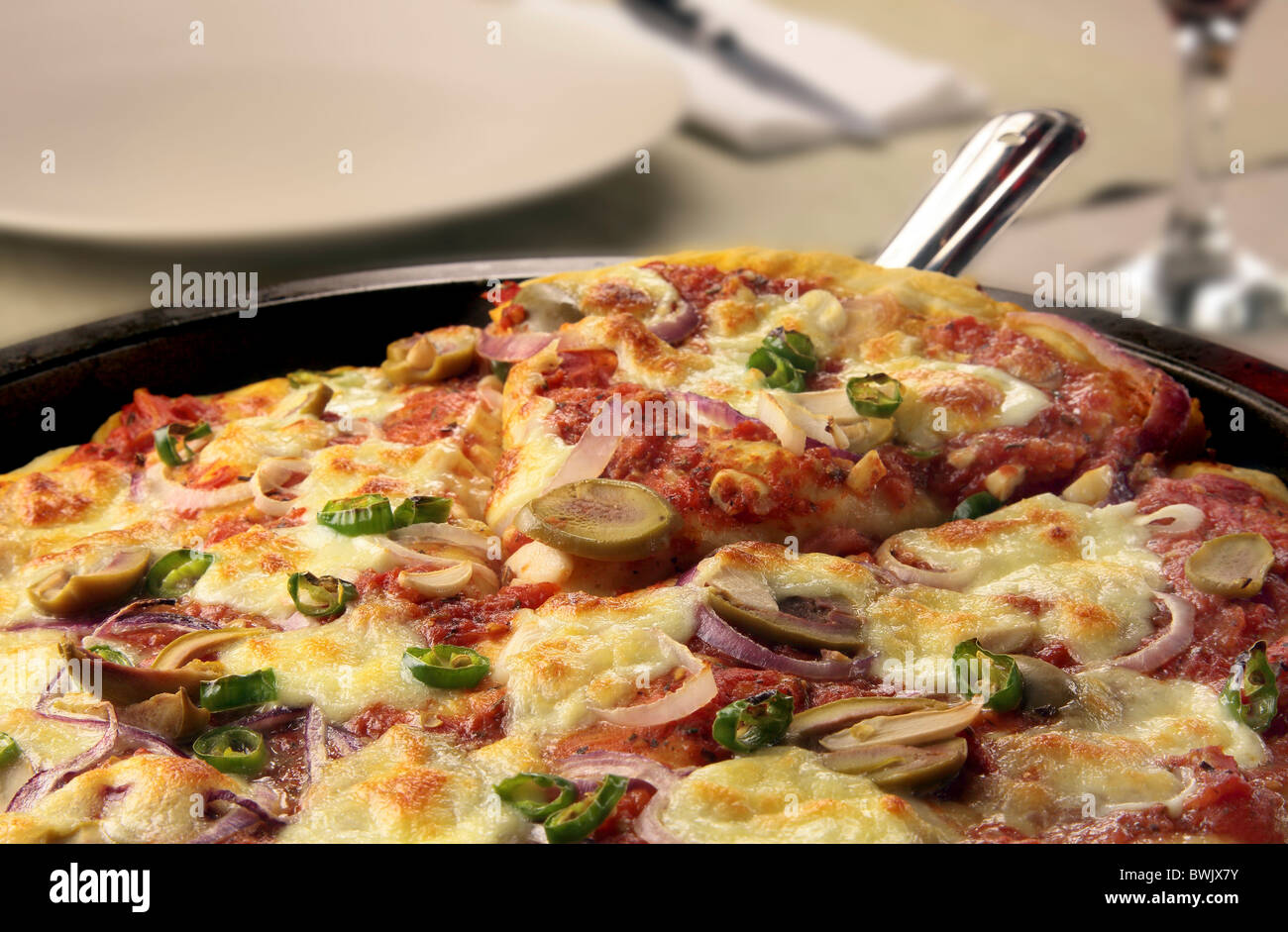Pizza with mozzarella, red onion, olives and chilis Stock Photo