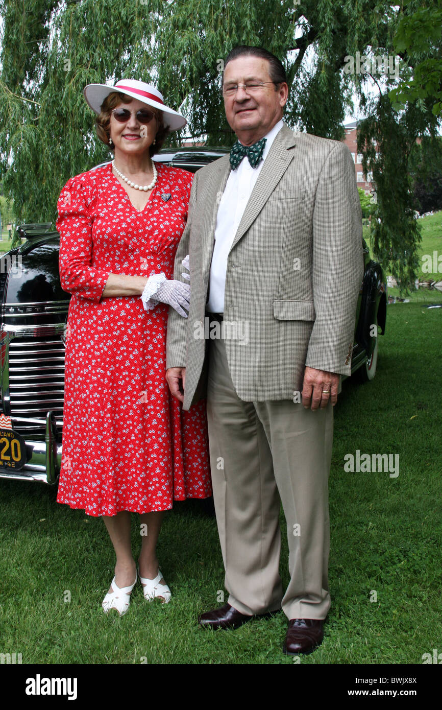 A World War II WWII couple in front of their antique vintage car 1945 Stock Photo