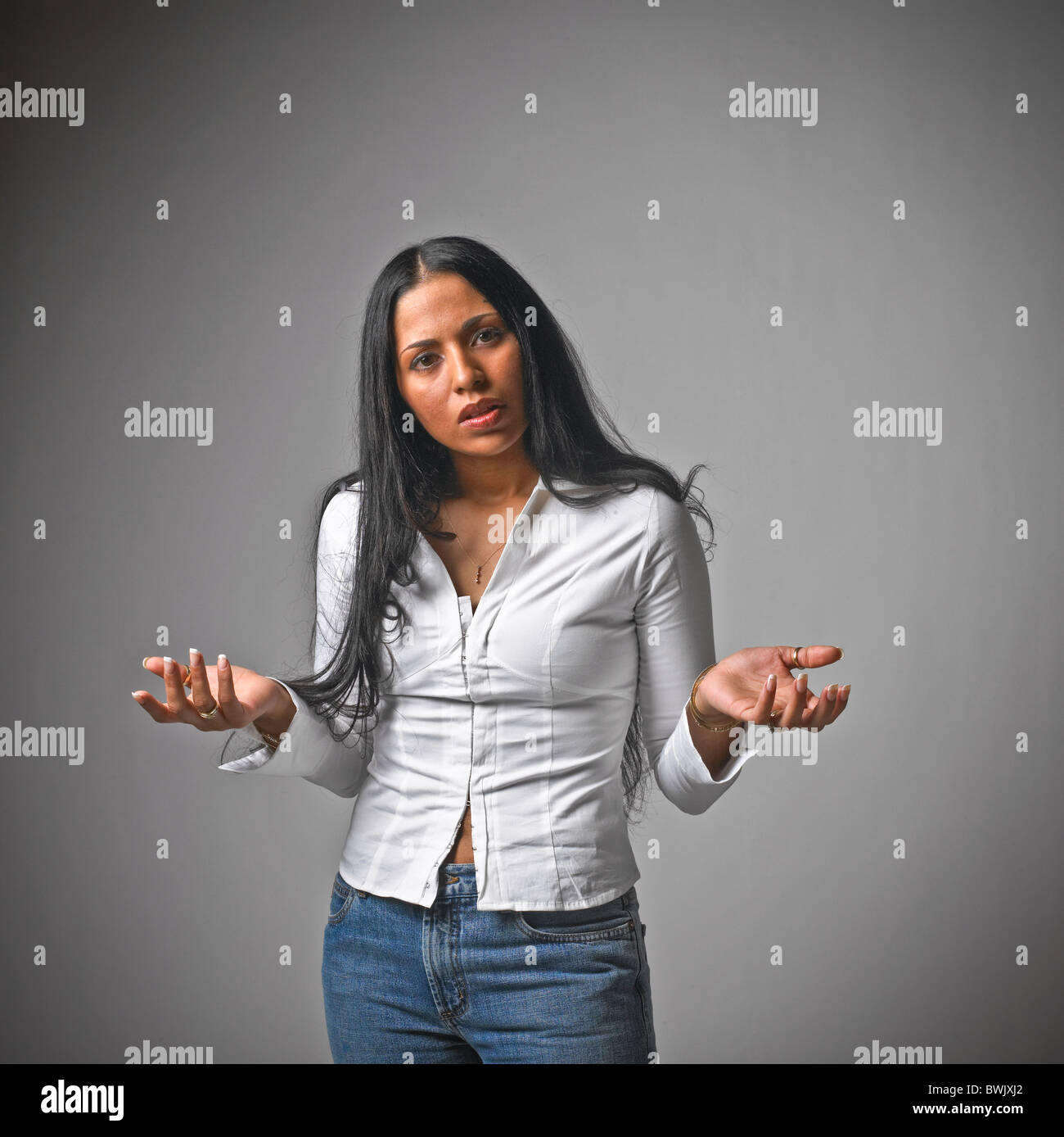 Young Hispanic woman female casual clothes, jeans, body language, Stock Photo