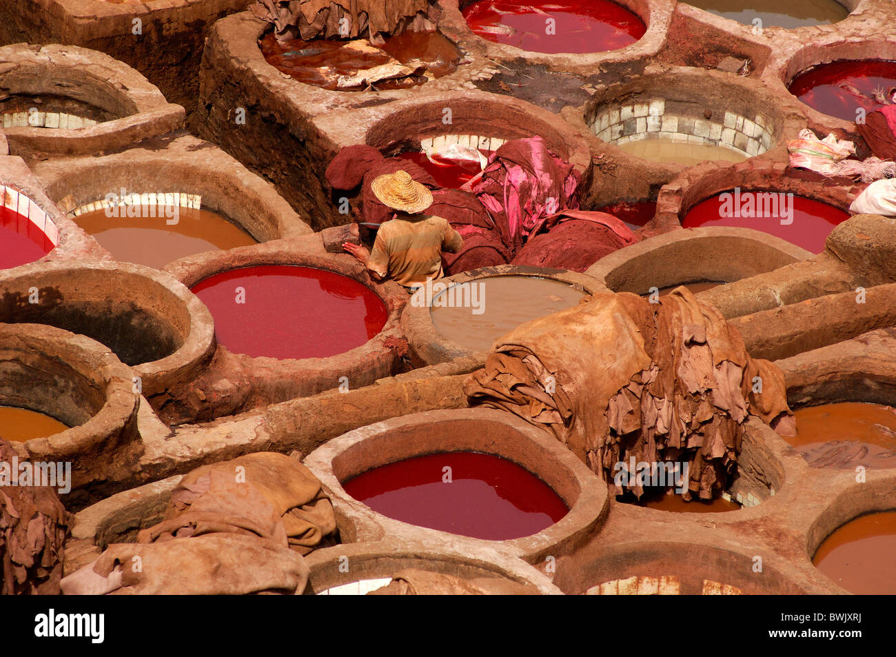 tanning tanner leather animal skins workers containers craft fir ream fez el Bali Medina Old Town fez Morocco North Africa Stock Photo