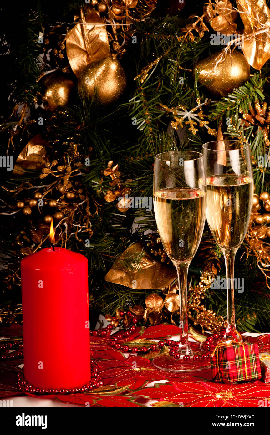 https://c8.alamy.com/comp/BWJXXG/two-glasses-of-champagne-christmas-candle-presents-and-decorations-BWJXXG.jpg