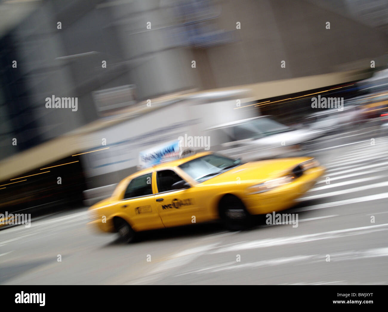 A yellow New York City taxi cab in motion in the United States of America Stock Photo