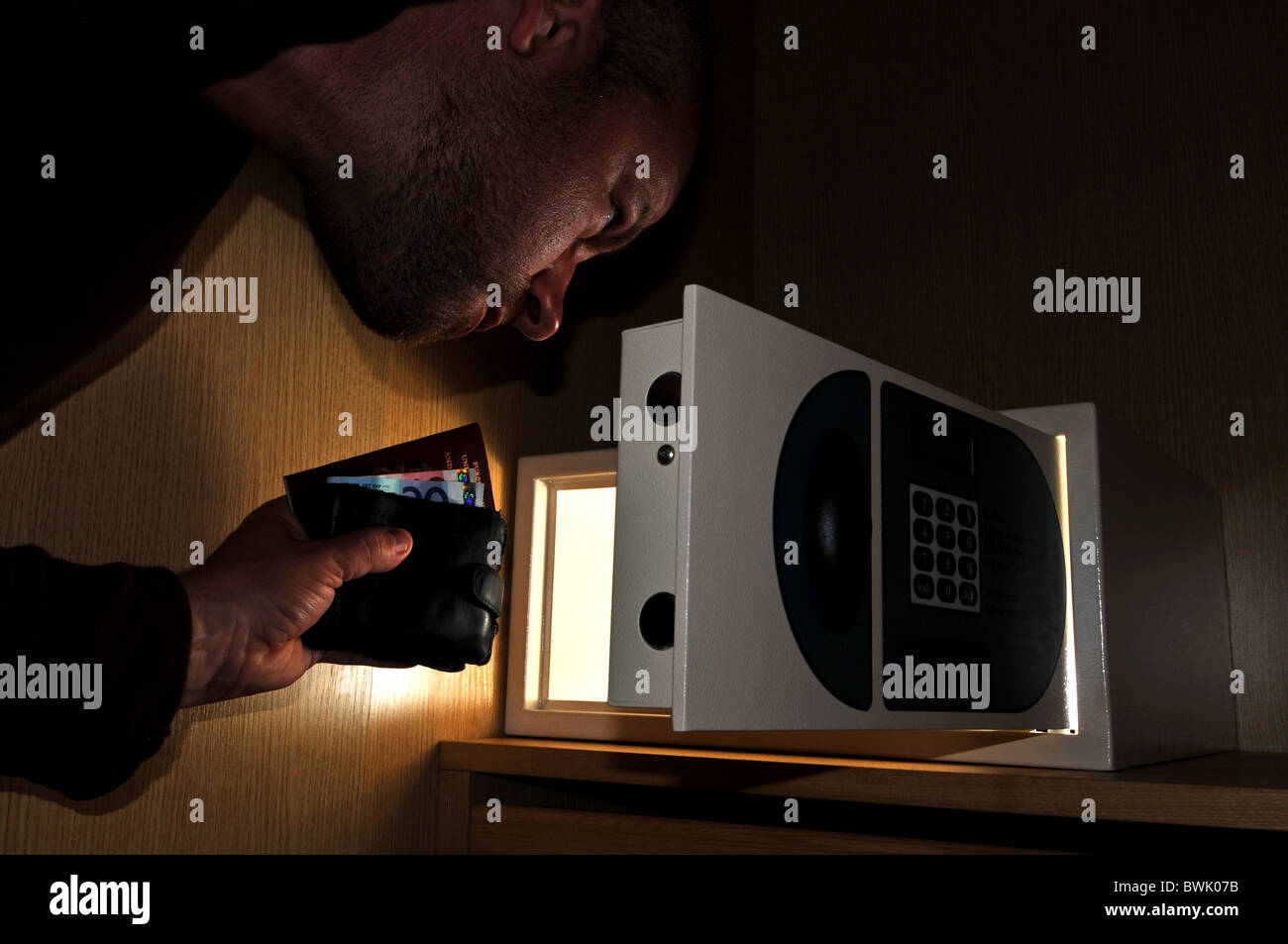 Safe, hotel safe, man taking belongings from a hotel safe Stock Photo