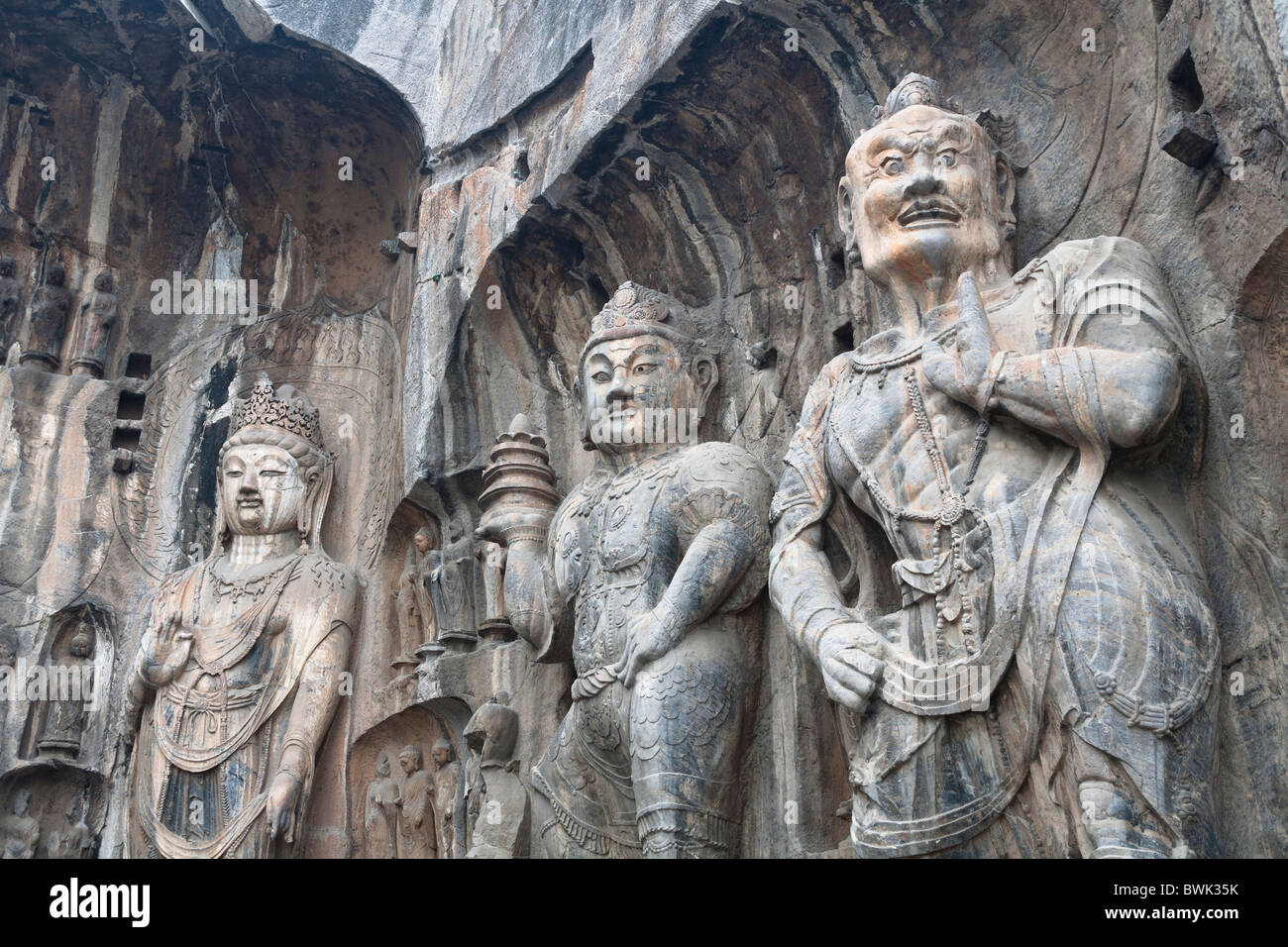 Carved statues, Fengxian Temple, Longmen Grottoes and Caves, Luoyang, Henan Province, China. Tang Dynasty Stock Photo
