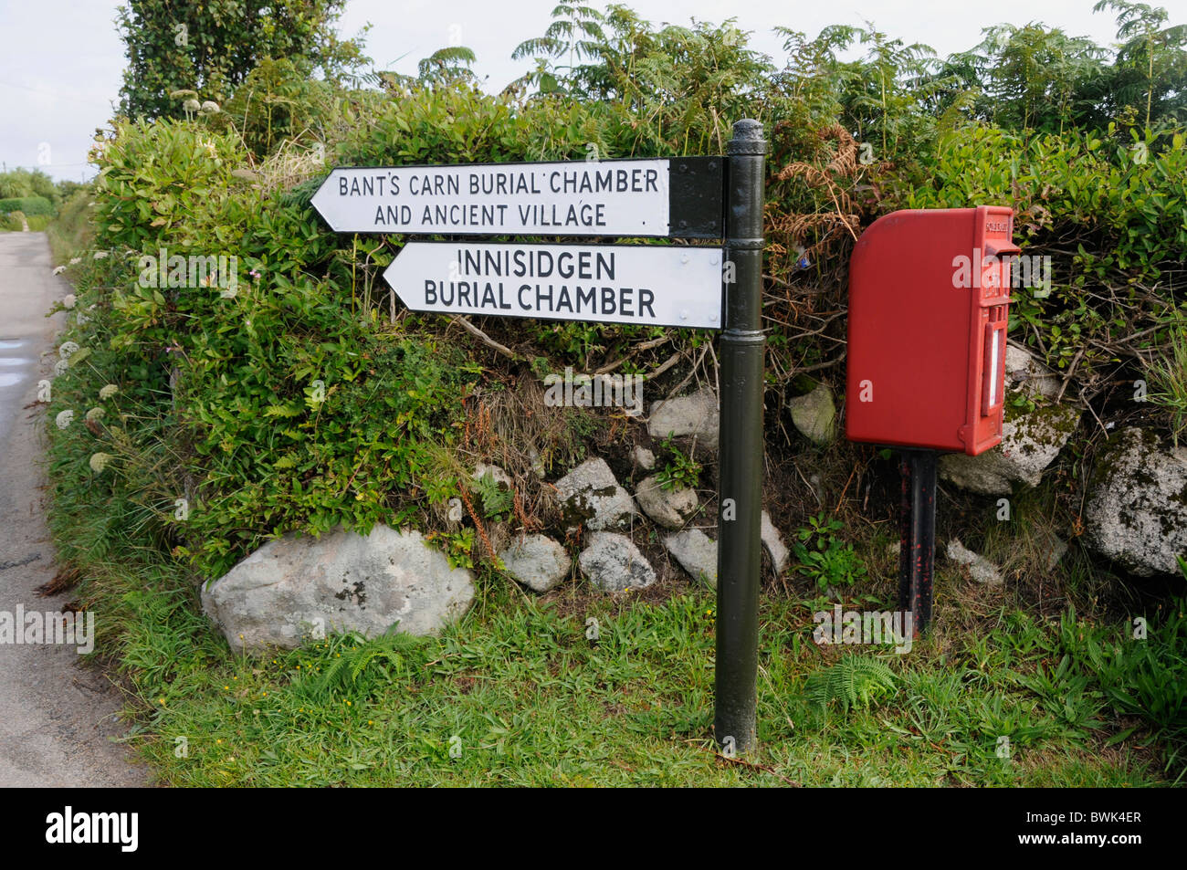 A sign to the Innisidgen burial grounds and a read Royal mail letter box on St. Mary's ,Isles of Scilly, Britain Stock Photo
