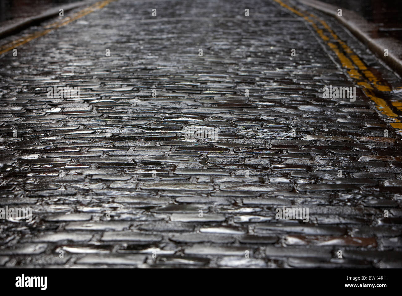 wet cobblestoned old narrow street in cathedral quarter area of belfast northern ireland uk Stock Photo