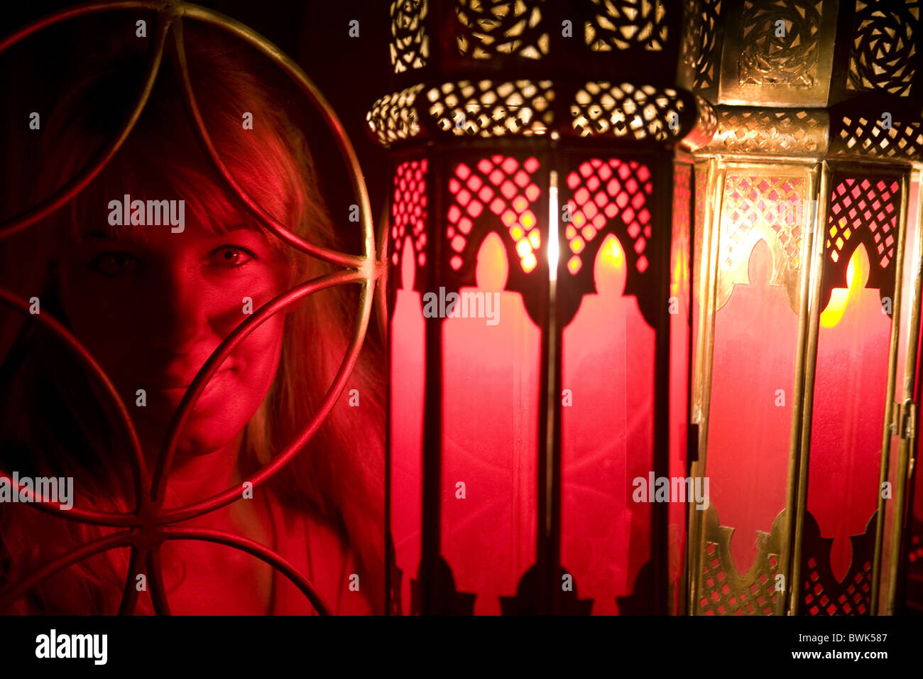 Woman poses in front of a Moroccan lamps at Café Arabe restaurant, Marrakech, Morocco Stock Photo