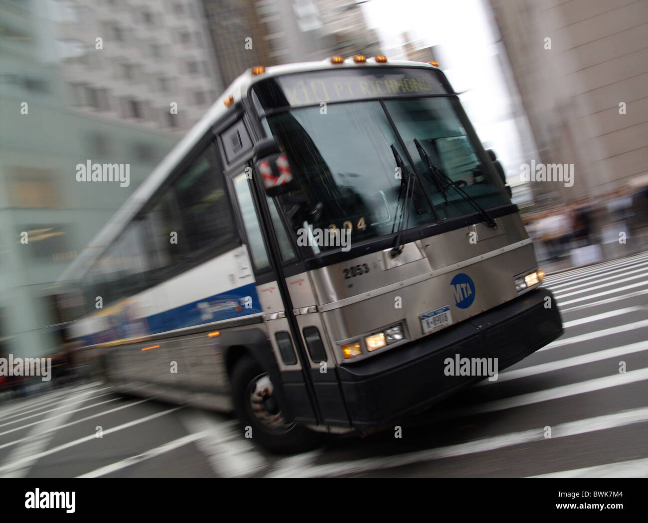 A bus turns a corner in New York City, United States of America Stock Photo