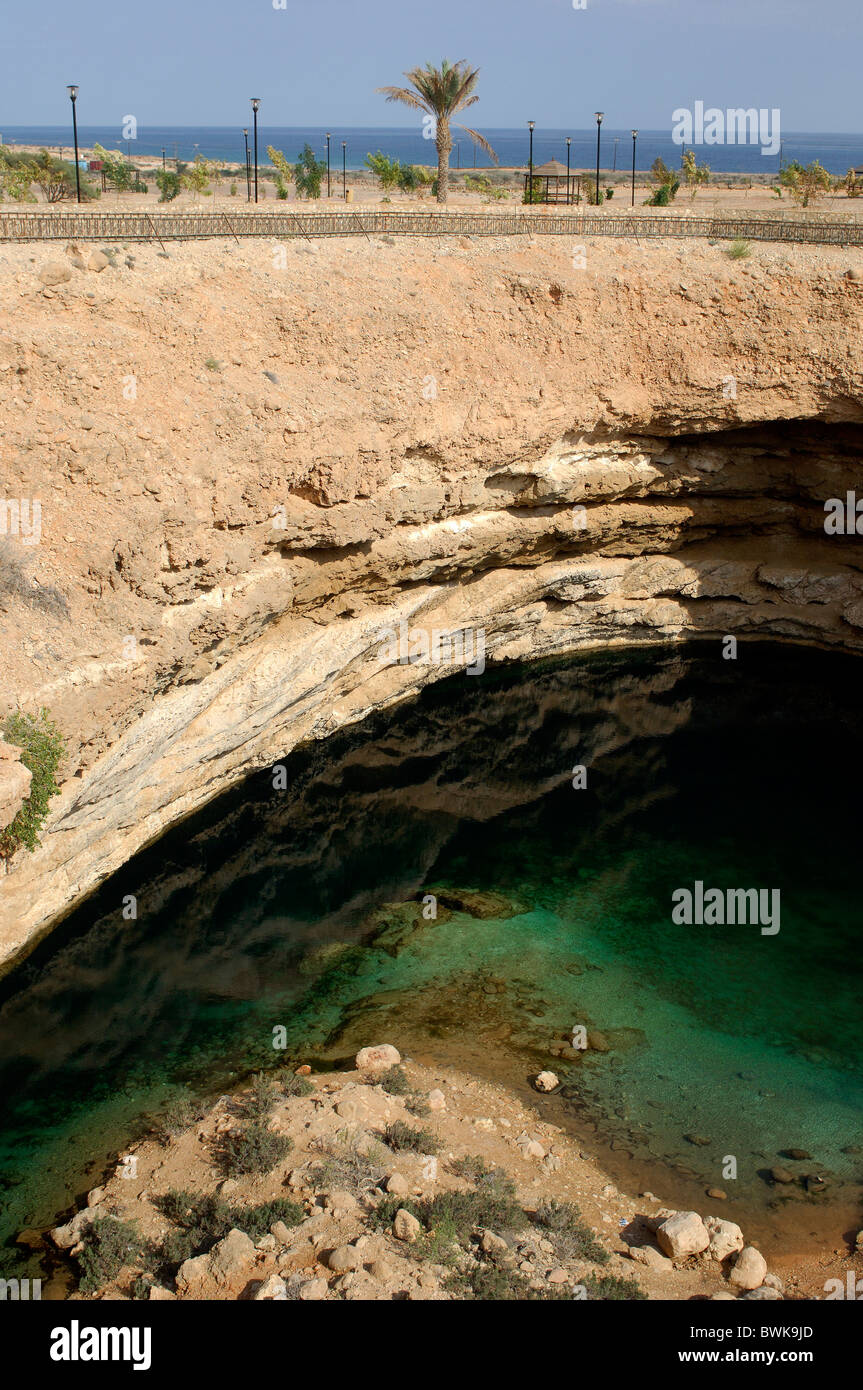 Bimah Sinkhole collapse funnel Doline two-pronged mattock limestone coast sea erosion geology Sur Coast Oman Stock Photo