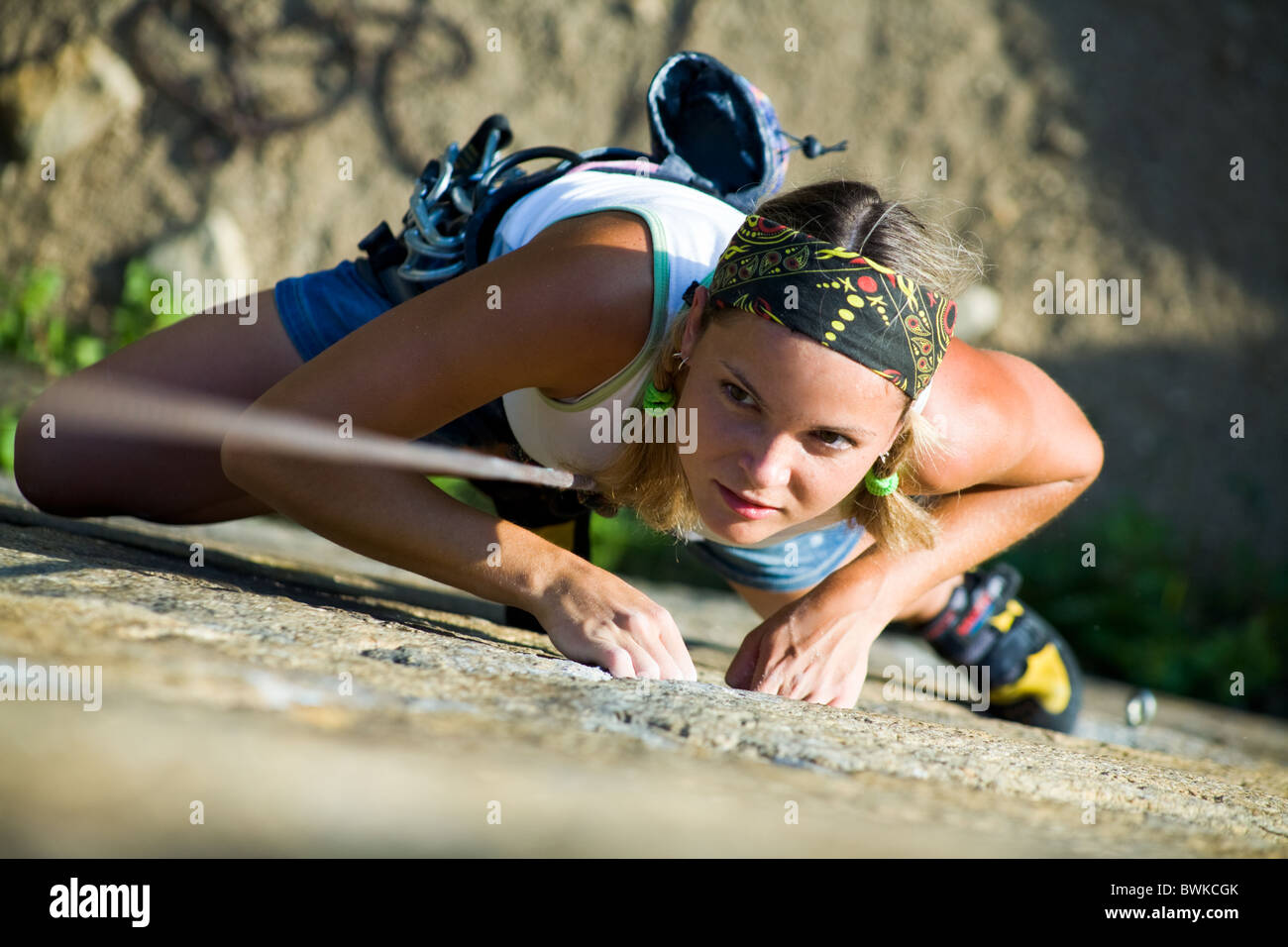 Image of pretty woman climbing on the rock Stock Photo - Alamy