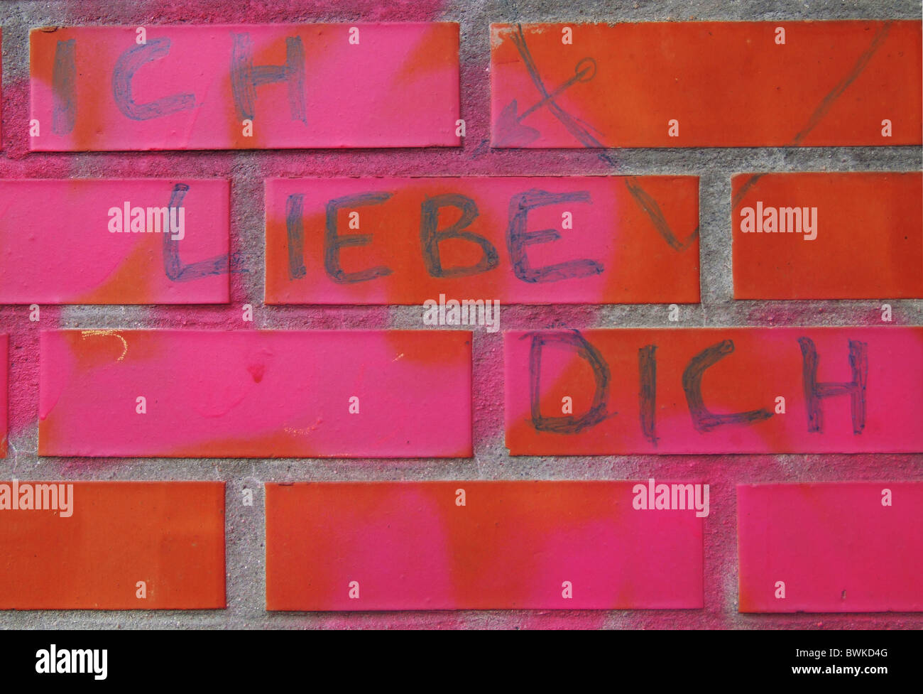 I love you declaration of love love heart graffiti wall pink red bricks writing smearings Stock Photo