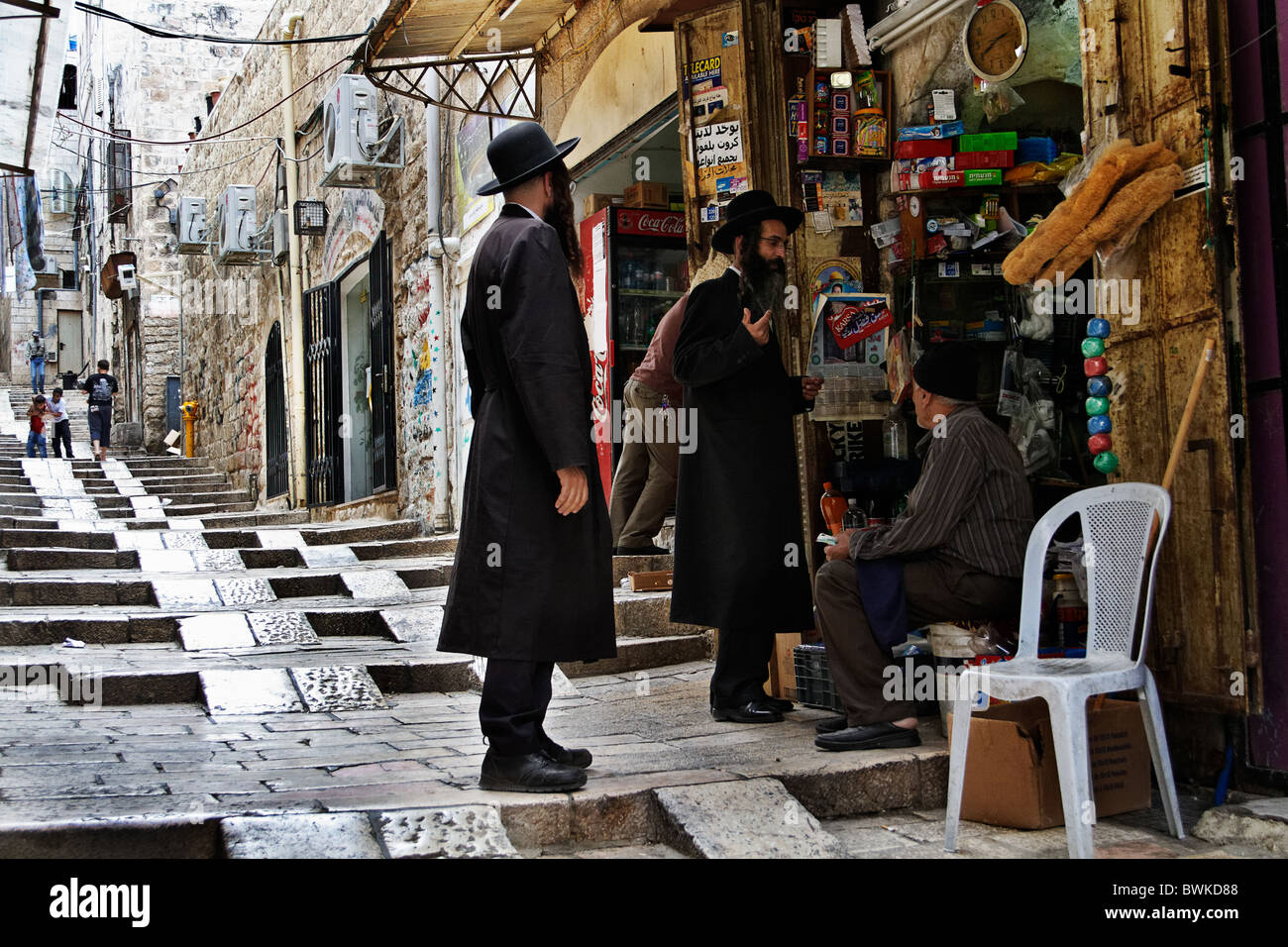Orthodox jews with an arab seller, old city of Jerusalem Stock Photo