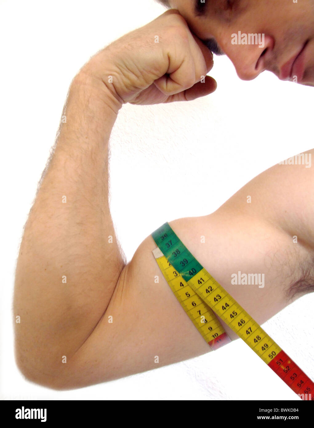 Impressive bicep on display. Muscular man measuring his bicep with a measuring  tape. Stock Photo by YuriArcursPeopleimages
