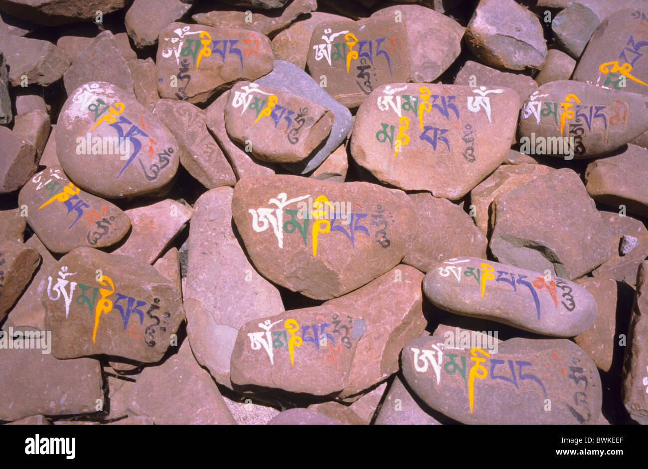 mani stones Om Mani Padme Hum inscription Mani stones symbols Mantra of sympathy Vajrayana Buddhism religion Stock Photo