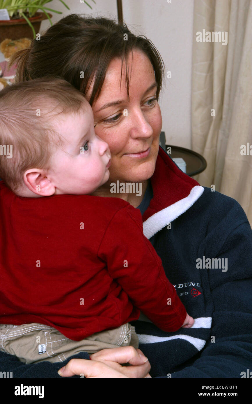 Satisfied mum hugging baby boy Stock Photo