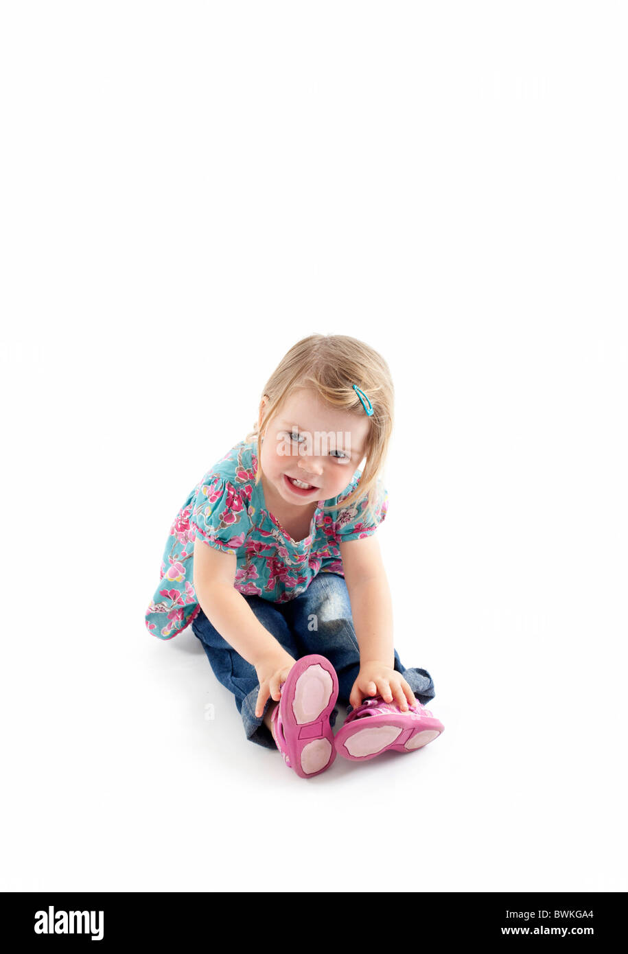 toddler sitting on floor with isolated white background Stock Photo - Alamy