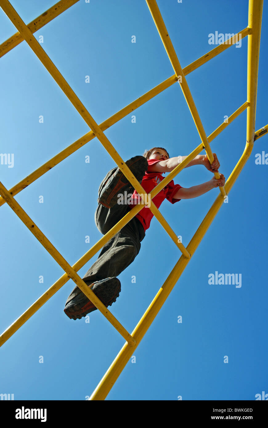 boy child boy Seven-year-old climbing scaffolding climbing scaffolding sky children playground playground pl Stock Photo