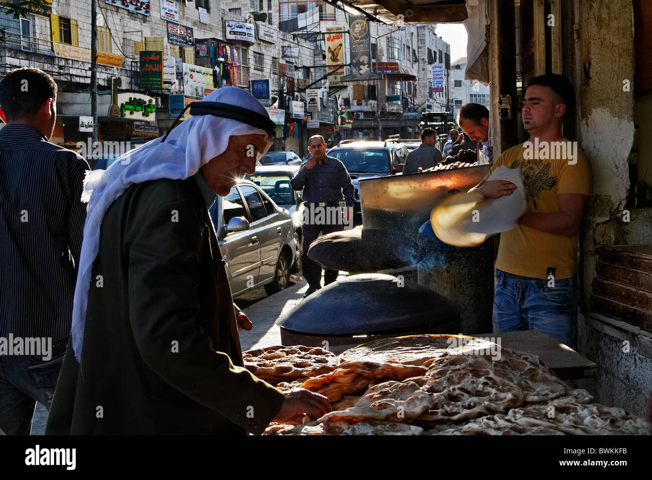 A palestinian in traditional clothing, choosing pita in a street of Ramallah Stock Photo