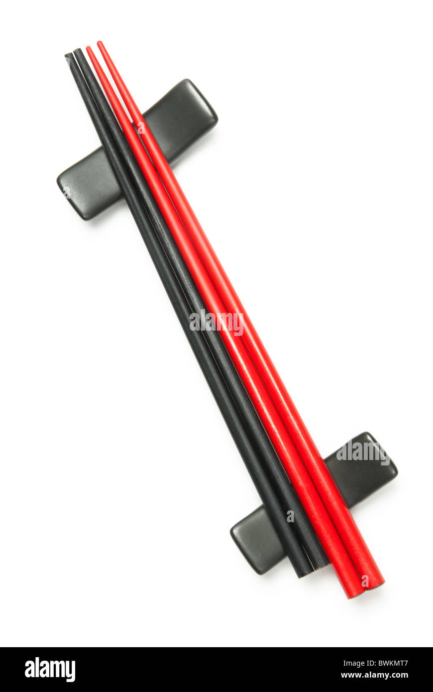 Red and black wodden chopsticks on holder over white Stock Photo