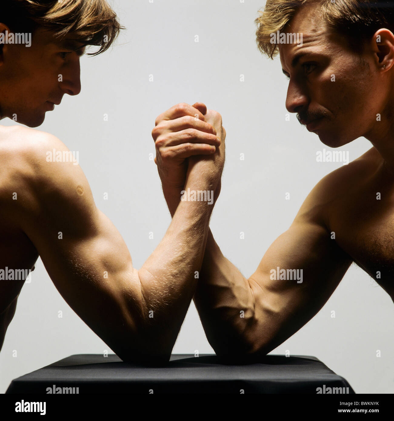 TWO MEN ARM WRESTLING Stock Photo