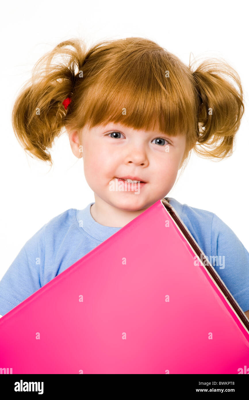 Portrait of small girl with textbook on a white background Stock Photo