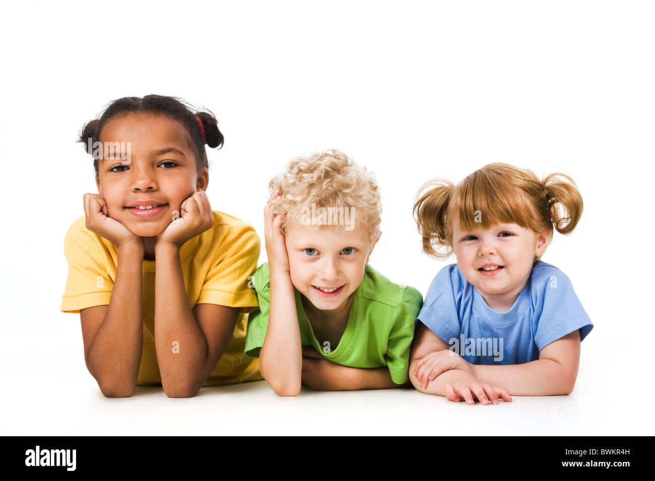 Row of children smiling and resting together Stock Photo