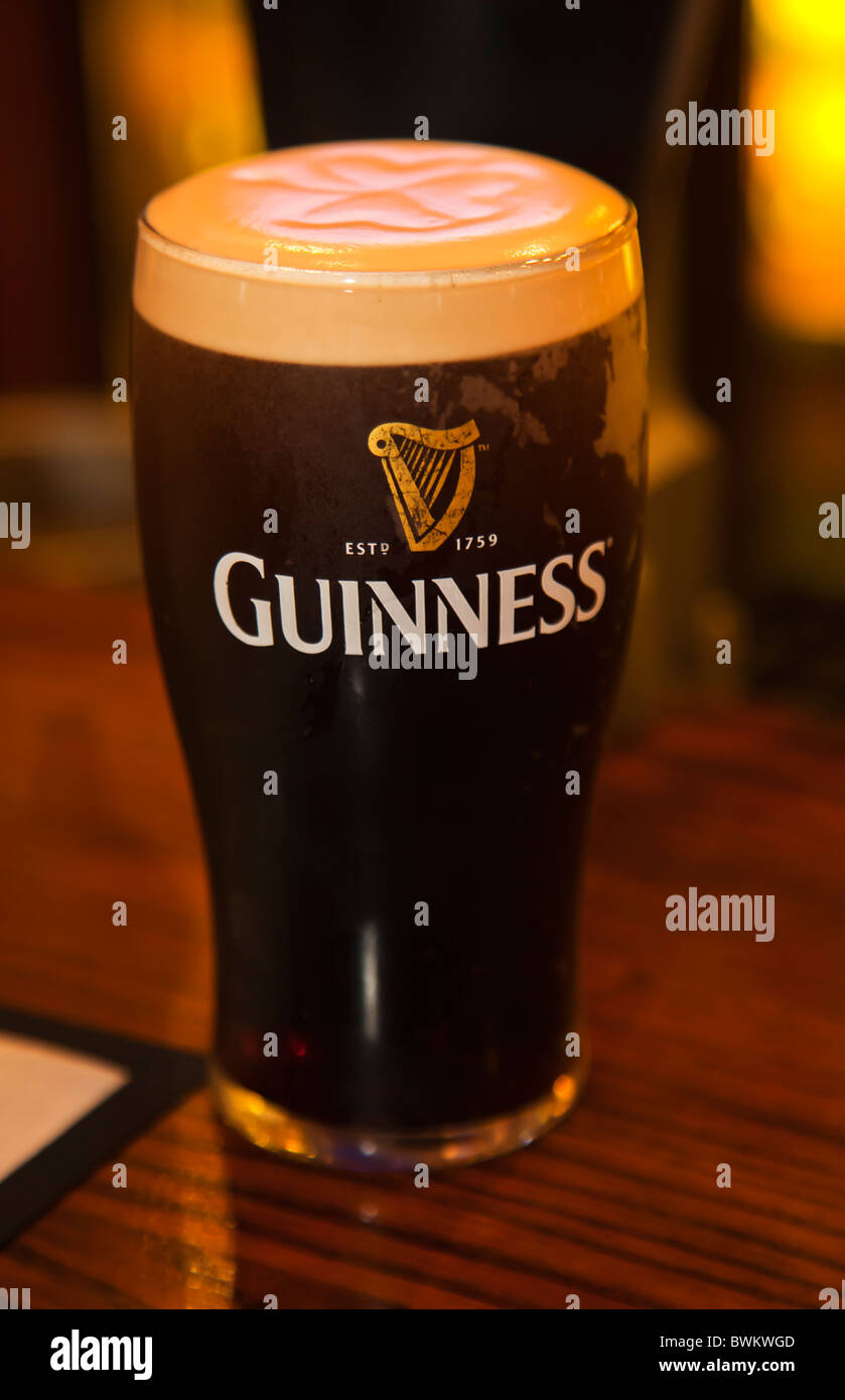 Fresh Draught beer pint of Guiness just served at pub Stock Photo