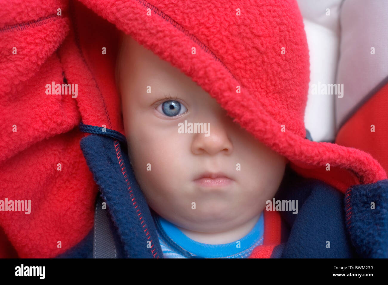 Baby boy 11 Months old toddler portrait child children hood red blue clothing one person Stock Photo